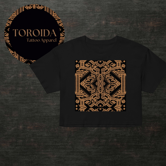 Black t-shirt with gold intricate design on a dark textured background, featuring 'TOROIDA Tattoo Apparel' logo.